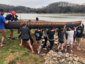 several UT students launch their concrete canoe