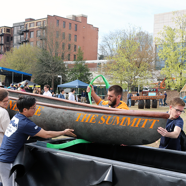 Several UT students slide their canoe into the box for the Swamp Test.