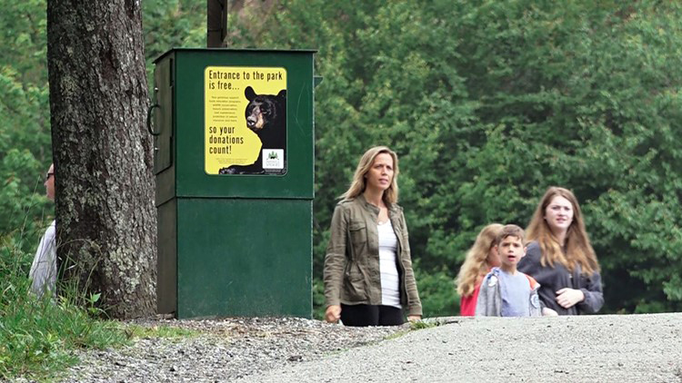 A family walks past a new donation box.