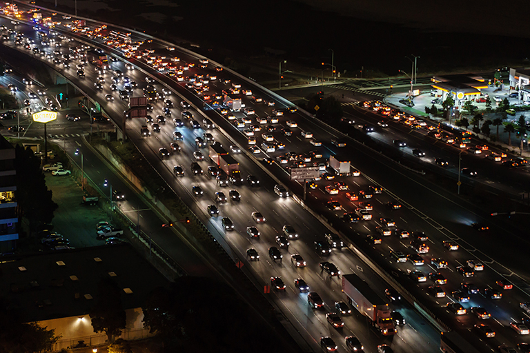 Birds-eye view of congested traffic on an interstate at night.