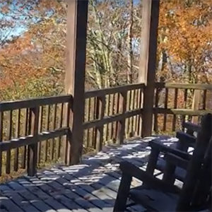 Rocking chairs on a deck overlooking the Smoky Mountains.