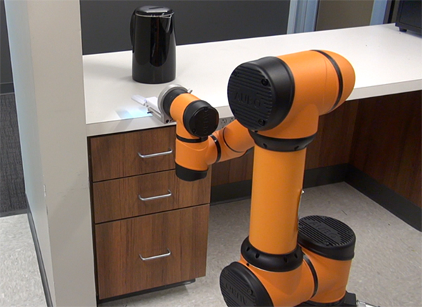 A robot cleans a counter.