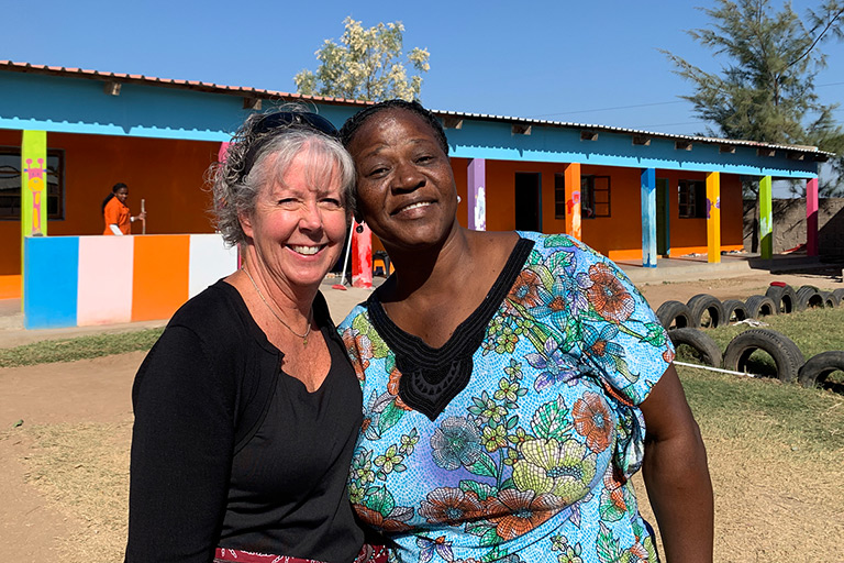 Angie poses with a woman on a mission trip.