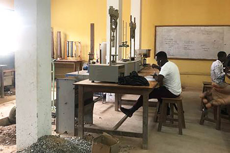 Student works in a Ghanian civil engineering lab.