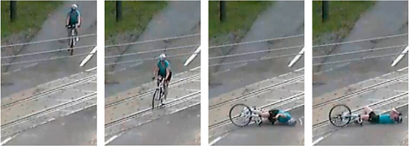 Series of video stills showing a bicyclist crashing at a railroad crossing.