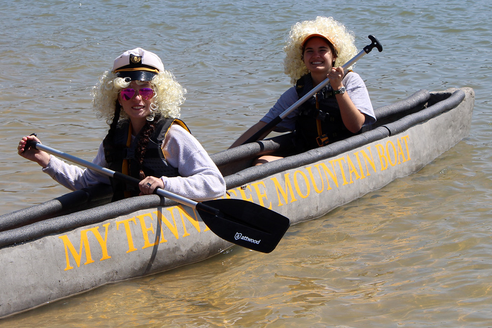 Two team members row in the concrete canoe.