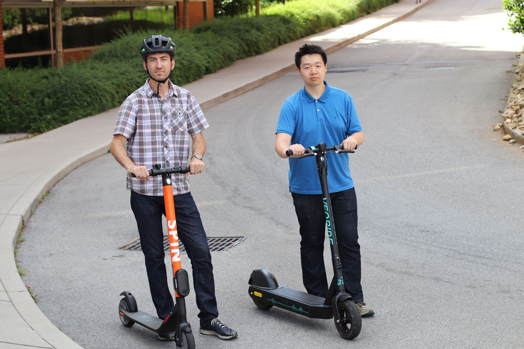 Chris Cherry and student on e-scooters