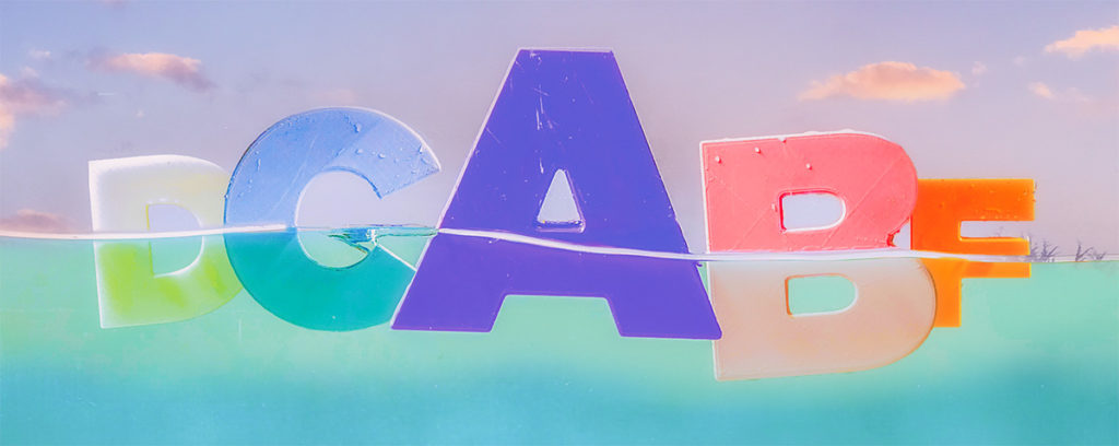 A graphic of colorful letters that appear to be floating in water with a sunset sky background