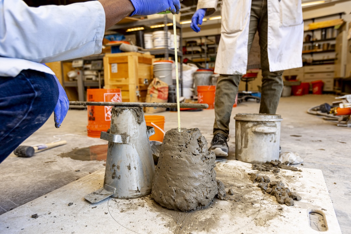 students in a lab creating concrete for research
