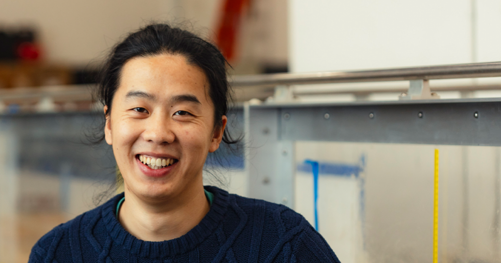 Haochen Li standing in a lab at the University of Tennessee