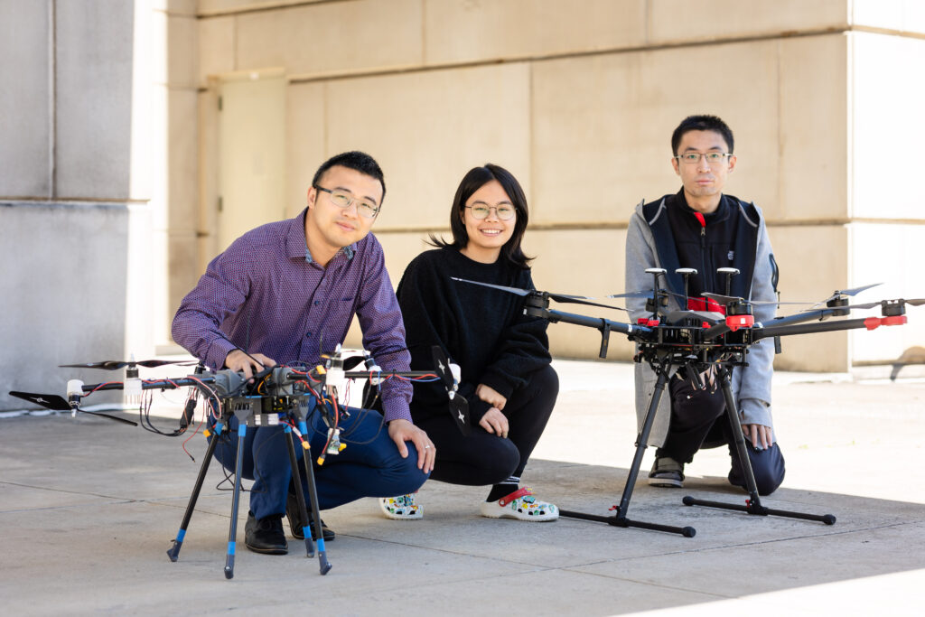 Shuai Li, Jiannan Cai, and Du Ha posing with the devices they created