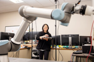 Jiannan Cai working on the technology she helped create with Shuai Li, Du Ha, and Jing Du