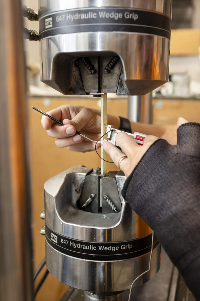 Arwood setting up a machine in a lab to run tests