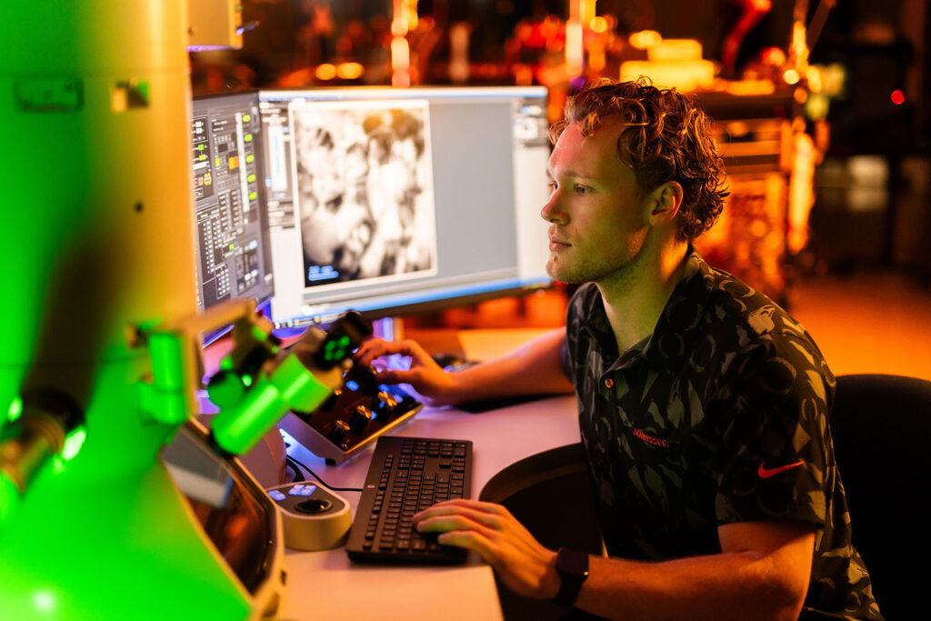 Andrew Wood works with computer in the IBML Lab.