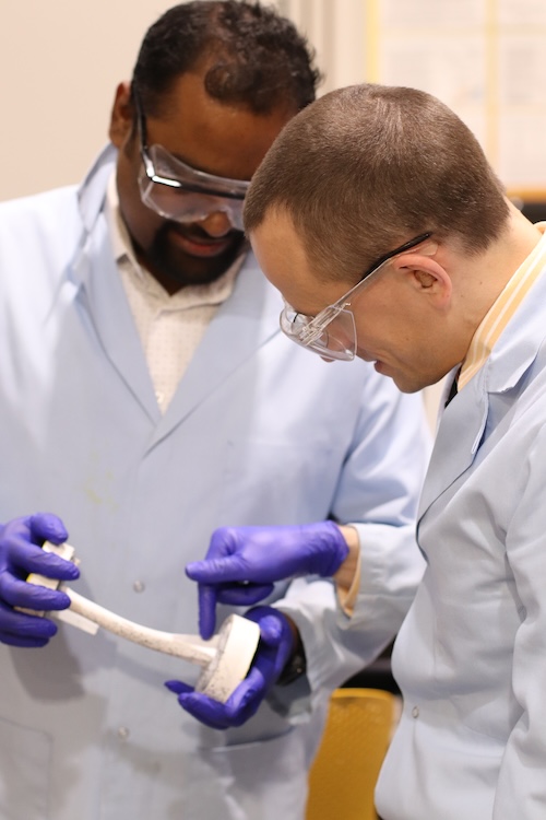 Debangshu Paul and Timothy Truster looking at a bone