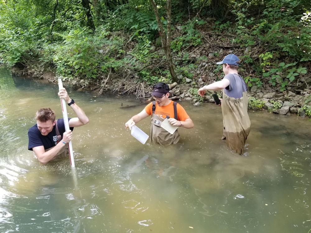 Tucker Martin and classmates performing research in a creek
