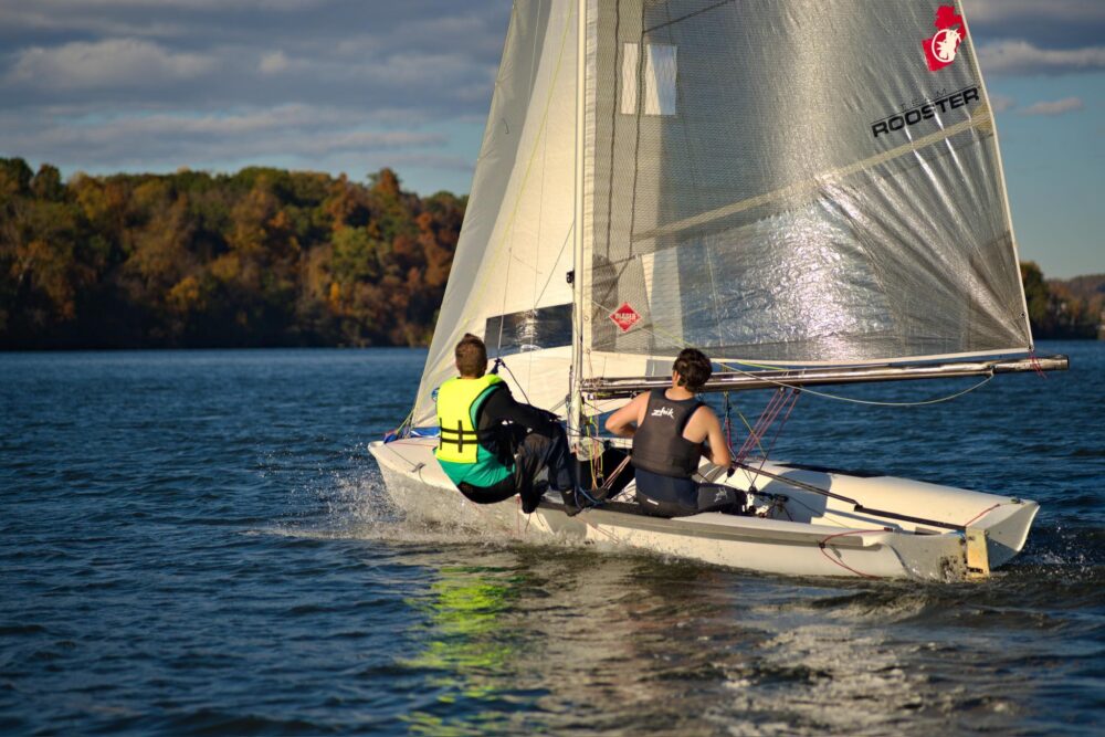 Tucker Martin and teammate sailing on the river