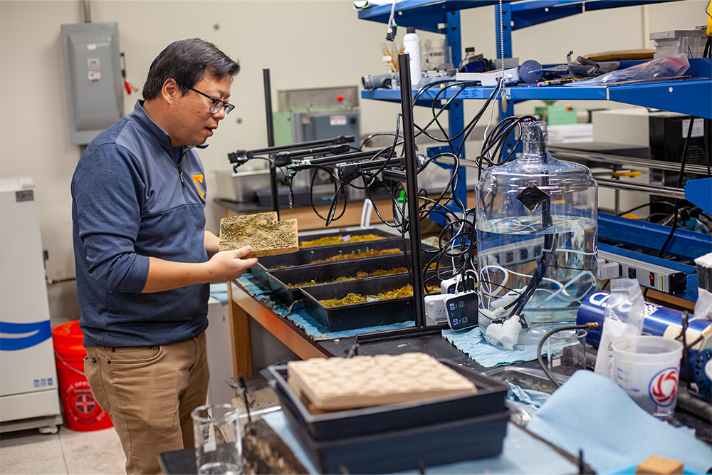 Zhou holding a phantom tile in the lab